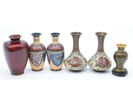 Six Japanese and Chinese vases comprising two cloisonné pairs, a Chinese example on wooden stand and a Ginbari red enamel exa