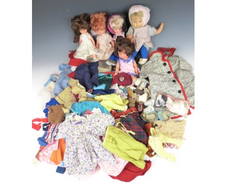 Four Mattel, Playmates and similar soft plastic dolls together with a collection of doll's clothing and outfits.&nbsp;