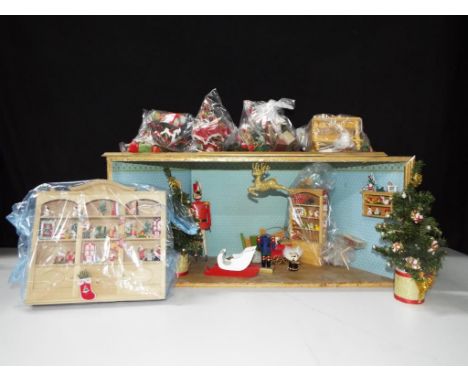 Dolls Houses - a wooden Christmas display, featuring Father Christmas with miniature toys, approximate height 28 cm x 62 cm [