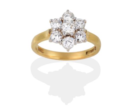 An 18 Carat Gold Diamond Cluster Ring, seven round brilliant cut diamonds in white claws to a yellow pointed shoulder plain p