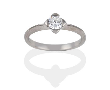 A Platinum Diamond Solitaire Ring, the round brilliant cut diamond in a white squared setting on a knife edge shoulder plain 