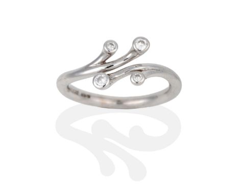 An 18 Carat White Gold Diamond Ring, four vari-sized round brilliant cut diamonds in rubbed over settings, each to an individ