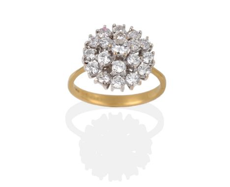 A Diamond Cluster Ring, the three tier cluster of round brilliant cut diamonds in white claw settings, to a yellow tapered sh
