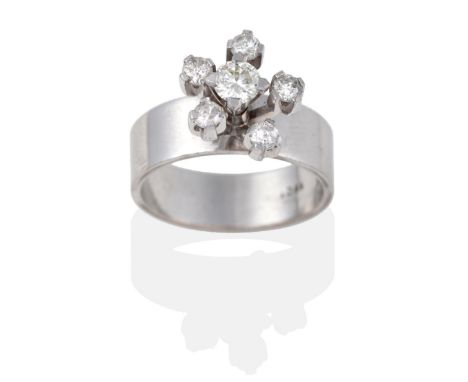 A Diamond Cluster Ring, a round brilliant cut diamond within a spaced border of mixed cut diamonds in white claws, on a broad