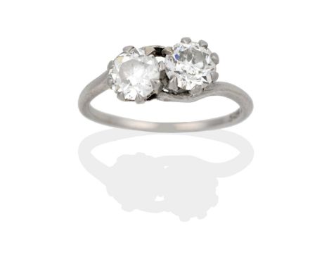 A Diamond Two Stone Twist Ring, the old cut diamonds in white claw settings, on a plain polished shank, total estimated diamo