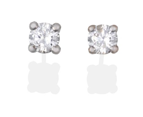 A Pair of 18 Carat White Gold Diamond Solitaire Earrings, the round brilliant cut diamonds in white claw settings, total esti