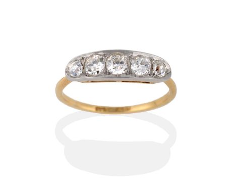 A Diamond Five Stone Ring, the graduated old cut diamonds in a white boat shaped setting, to a yellow tapered shoulder plain 