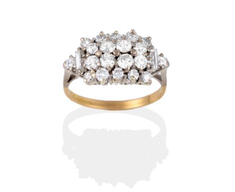 An 18 Carat Gold Diamond Cluster Ring, round brilliant cut diamonds in an oblong form, a baguette cut and a square cut diamon