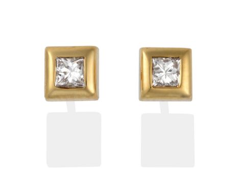 A Pair of 18 Carat Gold Princess Cut Diamond Solitaire Earrings, in broad rubbed over settings, total estimated diamond weigh