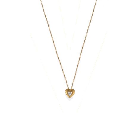 An 18 Carat Gold Heart Pendant on Chain, the yellow polished heart pendant with a heart shaped central opening inset with a r