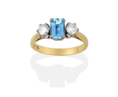 An 18 Carat Gold Aquamarine and Diamond Ring, the emerald-cut aquamarine between two round brilliant cut diamonds, in white c