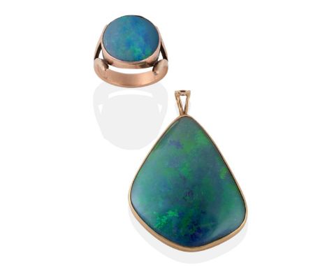 A 9 Carat Gold Composite Opal Pendant, of asymmetric form, measures 3.1cm by 4.4cm; and An Opal Ring, the round opal triplet 