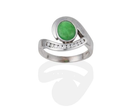 An 18 Carat White Gold Jade and Diamond Ring, an oval cabochon jade within a swirl frame with brilliant cut diamond accents, 