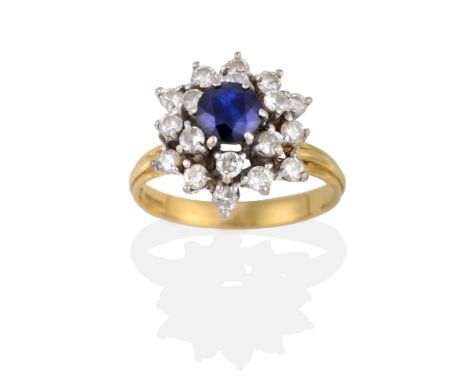 An 18 Carat Gold Sapphire and Diamond Cluster Ring, a round cut sapphire above spaced rows of round brilliant cut diamonds to