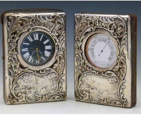 Two silver fronted desk watch easel frames (unmarked) containing a Goliath pocket watch with Swiss movement, and a London poc