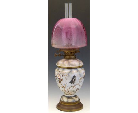 Aesthetic Movement table oil lamp the opaque glass body painted with prunus blossom, together with a ruby glass etched shade,