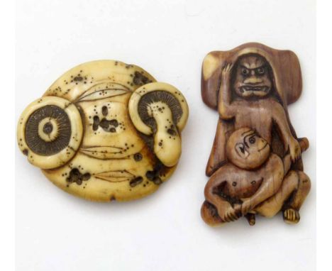 Japanese ivory manju-netsuke carved as a mushroom cap, width 4.5cm; a stained ivory netsuke depicting an oni and monkey, leng