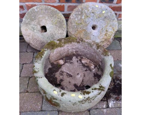 Two grindstones, 42cm and 37cm diameter each and circular trough.