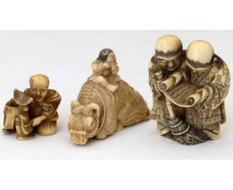 Japanese ivory netsuke of a boy on the back of an ox, length 6cm; Meiji period; an ivory netsuke of two boys with a scroll an