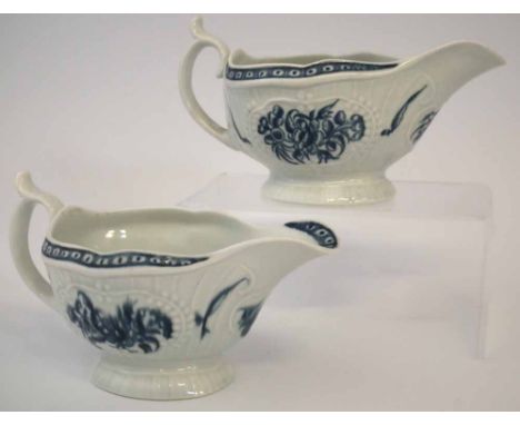 Two Worcester sauceboats circa 1770 with strap flute moulding, painted with flora in underglaze blue, crescent mark to base, 