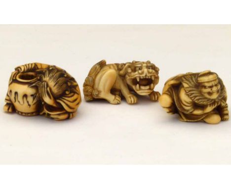 Japanese ivory karakuri-netsuke of a lion of Fo with a ball in its mouth, 4cm; an ivory netsuke of a despairing figure with a