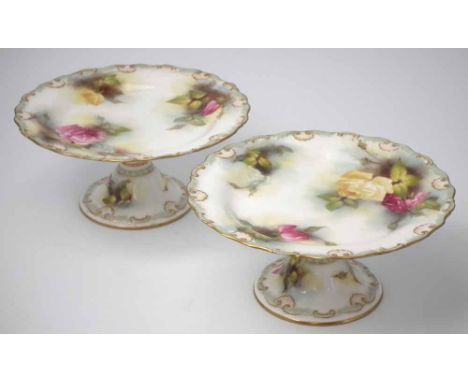 Pair of Royal Worcester footed comports signed M. Blake, painted with roses, dated code for 1909, (2) 23cm diameter     Condi