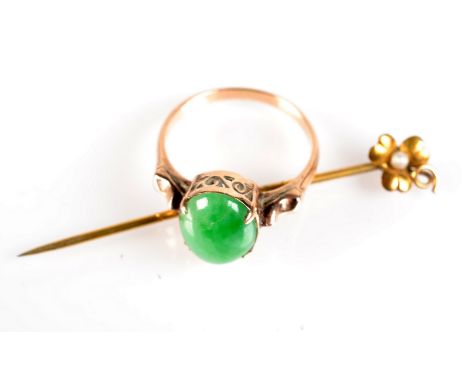 An 18ct jade ring and a gold stick pin.