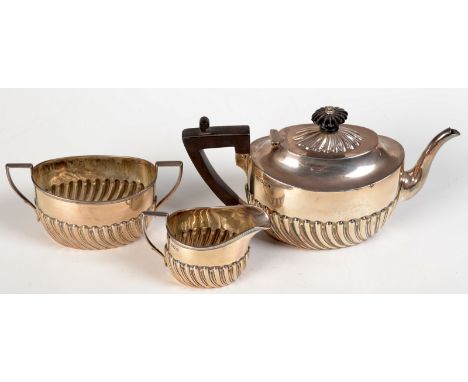 An Edwardian silver three piece bachelors' tea service, each of half fluted oval form, Sheffield, 1909, 11.5ozs.