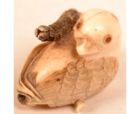 An ivory netsuke in the form of a chick, signed Seiichi.