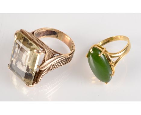 A gold ring set with 'green stone' jade and a gold dress ring set a large citrine.