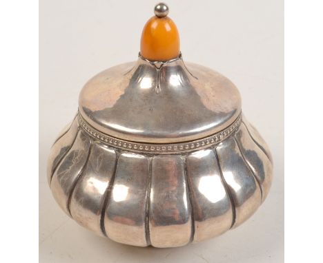 A Scandinavian silver trinket box of bulbous circular form with beaded rim and amber finial. Condition Report: This is in goo