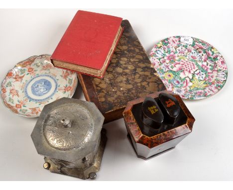 A lacquered tea caddy, one other tea caddy, a two plates, and two books.