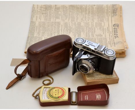 A Voigtlander Vito II folding 35mm camera in a brown leather ERC, together with an Ikophot light meter, a box of glass negati