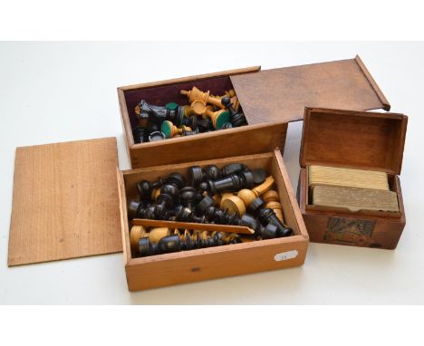A turned wood chess set in a pine box, together with a Staunton pattern chest set, and a wooden card case and contents.