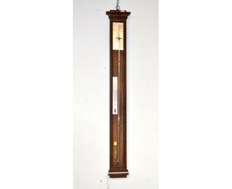 A stick barometer with a stainless steel scale on an oak mount.