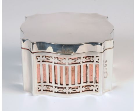 An Edwardian silver tea caddy box of shaped square section, each panel pierced to reveal a hammered copper liner, by Levi & S