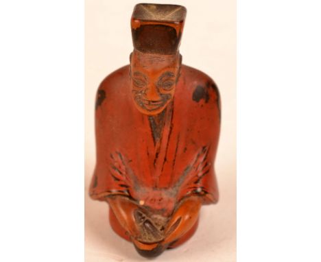 A Japanese Tokyo school seated priest carved and lacquered netsuke. 