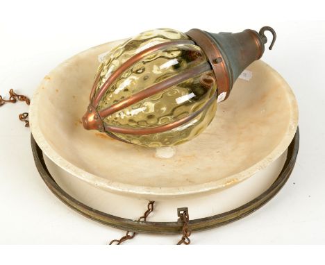 A copper light fitting with a blown green glass shade and a circular brass light fitting with a stone shade.