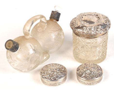 A pair of conjoined glass oil and vinegar bottles with silver necks, lacks stopper, together with a cut glass powder bottle w