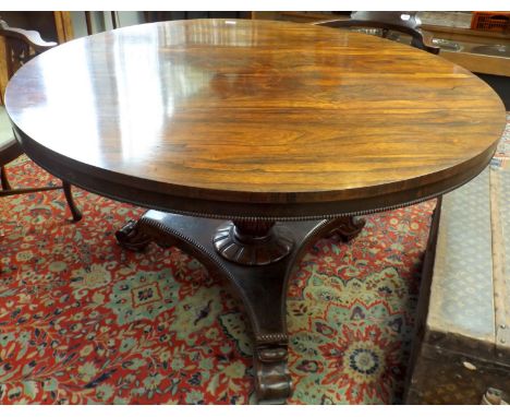 An early Victorian rosewood veneered circular snap top table with tripod base, diameter 127cm.