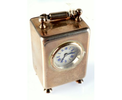 A miniature silver cased carriage clock.  Maximum height 5.3cm. Condition Report: The clock ticks, it has been worked on as w