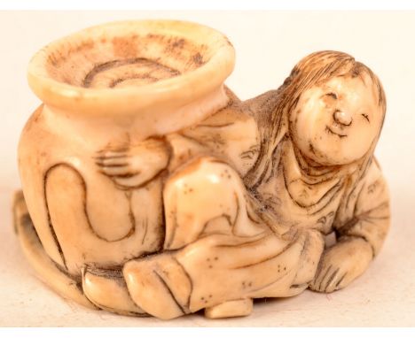 An ivory netsuke with a figure by a large jar representing the story of Chiva Onka.