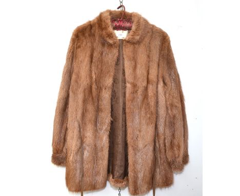 A 'Higg's Furs' short musk wash coat with leather belt tie.