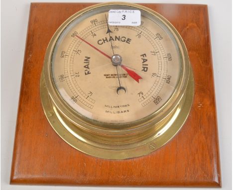 A ship brass bulkhead aneroid barometer, by Sestrel, dial diameter 14cm.