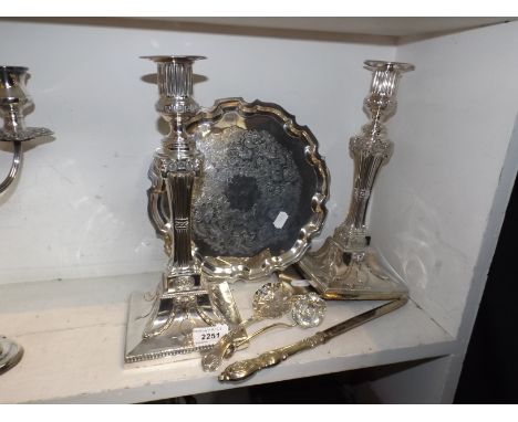 A pair of Sheffield candlesticks embossed with rams' head, and swags, together with two spoons, a cigarette case and a silver