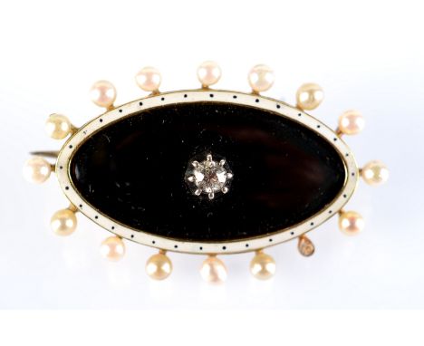 A navette shaped gold brooch with a central diamond within black and white enamel and a pearl border.