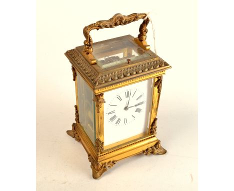A good 19th century French repeating carriage clock, the gilt brass case with ornate chased cast mounts, the movement with si