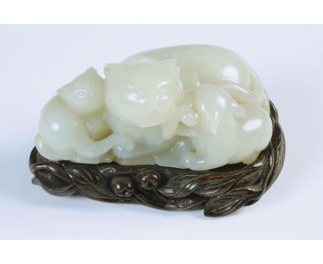 A good jade group carved with three animals on a leaf, they feed on leaves.  Width 9.5cm. Carved stand. (See illustration) Co