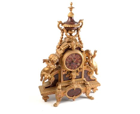 An ornate nineteenth century French sculptural mantel clock with red marble dial and panels, height 57cm.