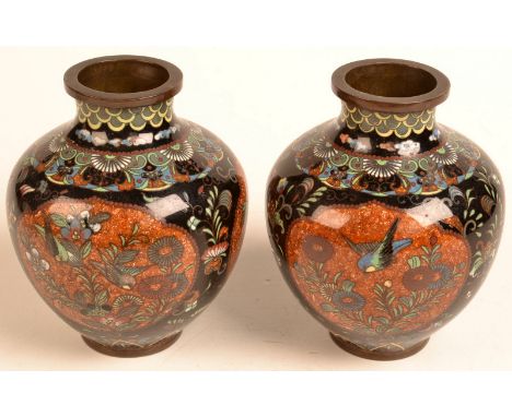 A pair of Japanese cloisonne, globular vases with black ground and gin-bari panels.  Height 12cm.  Condition Report: Dent to 